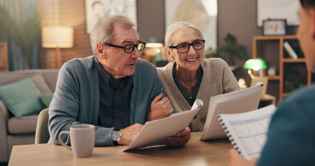 Man and woman with pamphlets open talking to someone in the foreground